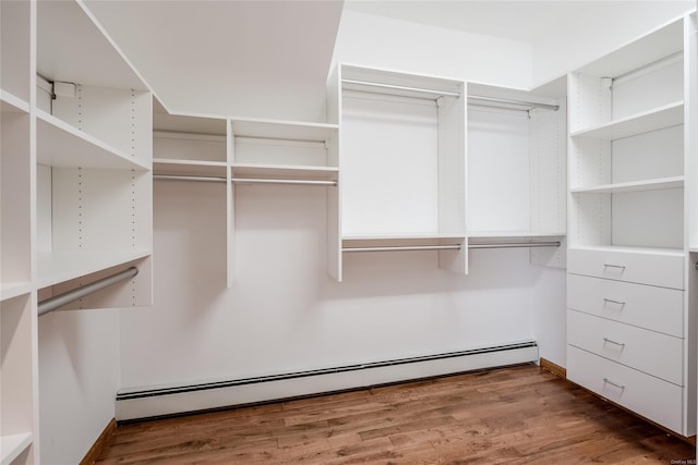 walk in closet with hardwood / wood-style floors and baseboard heating