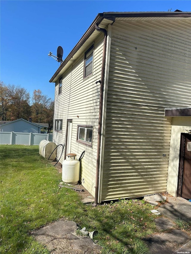 view of side of property featuring a yard