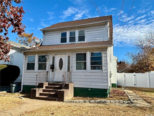 18 Perry St, Hempstead, NY 11550 - american foursquare style home with a gate, oil tank, and entry steps
