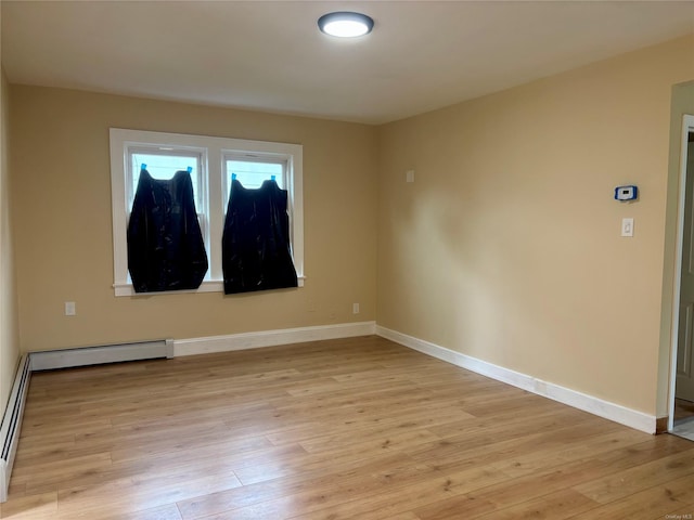 18 Perry St, Hempstead, NY 11550 - spare room with light wood-style floors and baseboards
