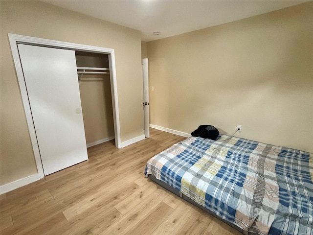 18 Perry St, Hempstead, NY 11550 - bedroom with wood finished floors, baseboards, and a closet