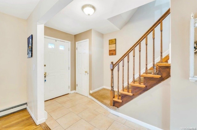 tiled foyer featuring a baseboard heating unit