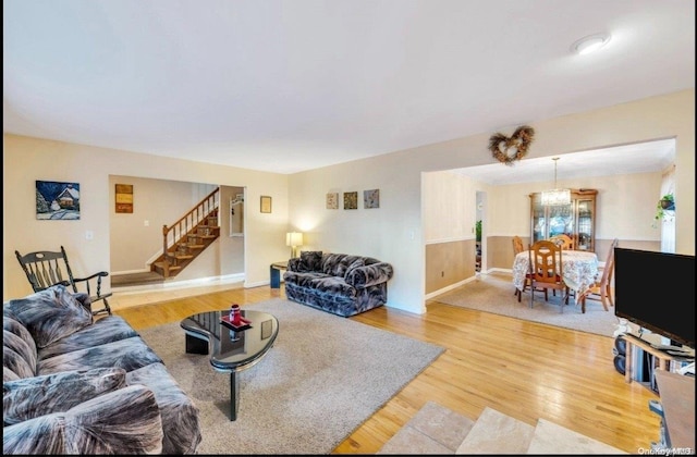 living room featuring a chandelier and wood-type flooring