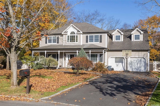 view of front of home featuring a porch and a garage