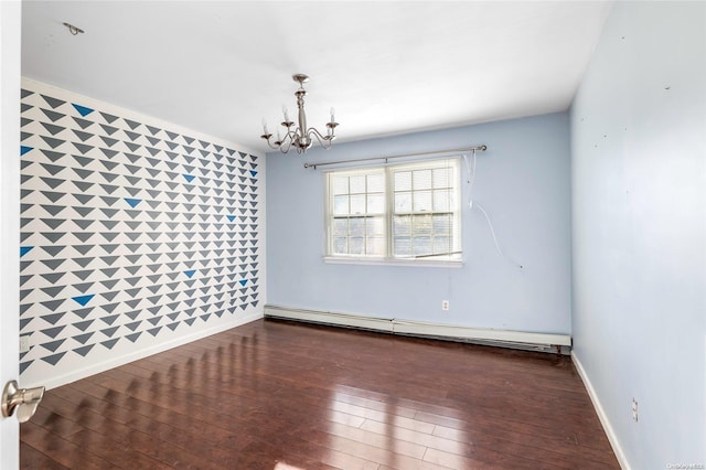 unfurnished room featuring dark wood-type flooring, tile walls, a baseboard heating unit, and a notable chandelier