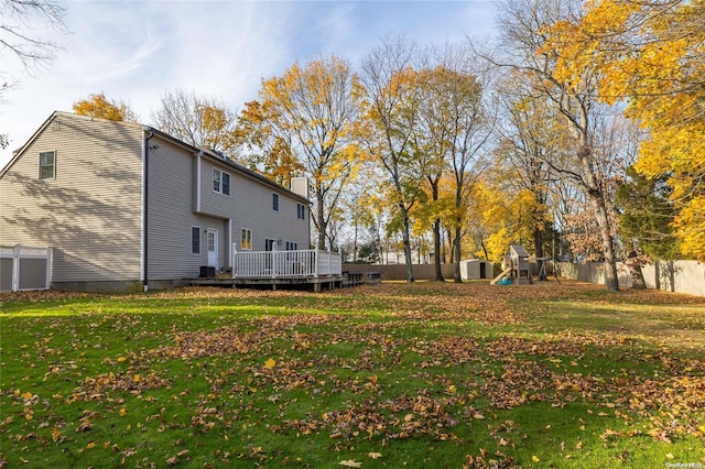 view of yard featuring a storage unit and a wooden deck