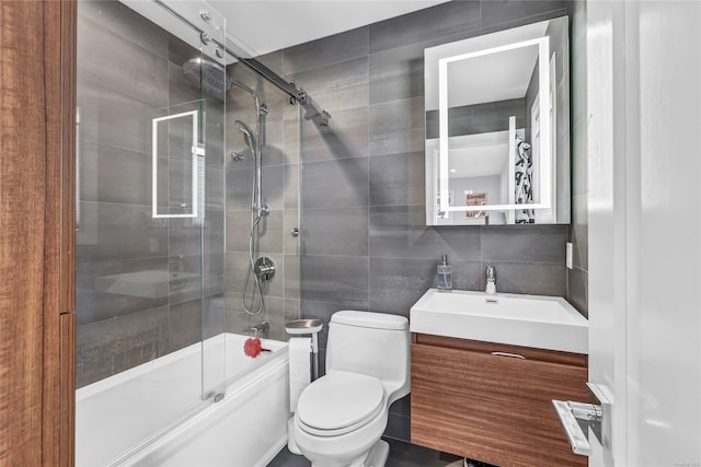 full bathroom with vanity, decorative backsplash, toilet, enclosed tub / shower combo, and tile walls