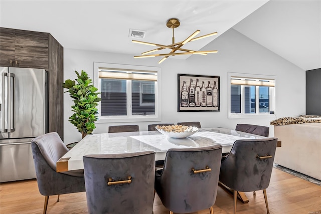 80 Illinois Ave, Long Beach, NY 11561 - dining room with light wood-style floors, vaulted ceiling, and a chandelier
