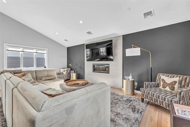 living room with wood-type flooring and lofted ceiling