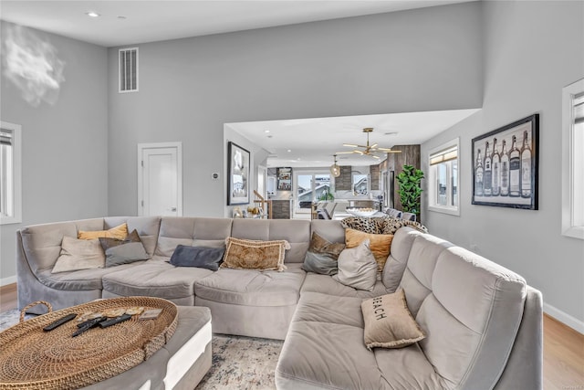 living room with a high ceiling and light hardwood / wood-style flooring