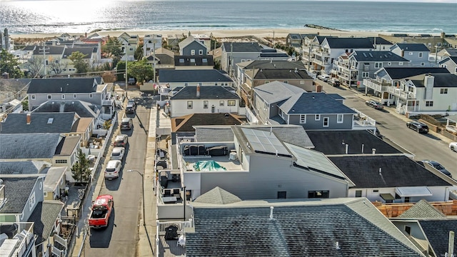 aerial view with a water view and a beach view