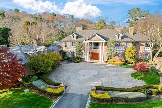 660 Chicken Valley Rd, Matinecock, NY 11560 - view of front facade with curved driveway and a chimney