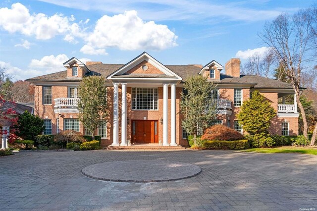 660 Chicken Valley Rd, Matinecock, NY 11560 - neoclassical / greek revival house with a chimney and brick siding