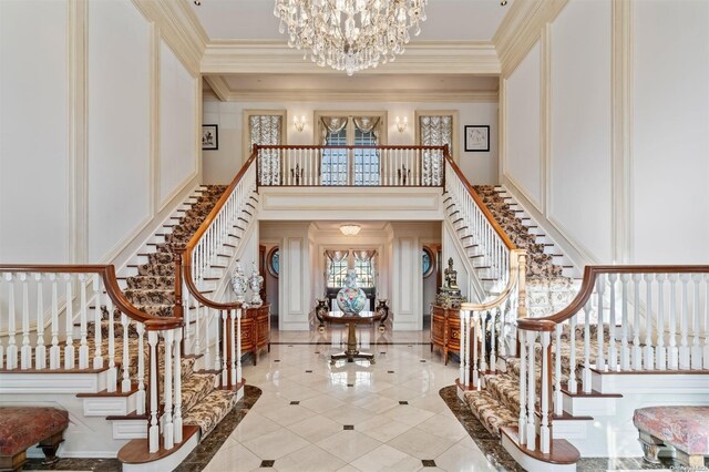 660 Chicken Valley Rd, Matinecock, NY 11560 - entrance foyer with stairs, a chandelier, a decorative wall, crown molding, and light tile patterned floors
