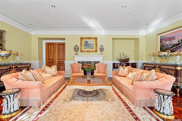 living room featuring wood-type flooring, crown molding, and a high end fireplace