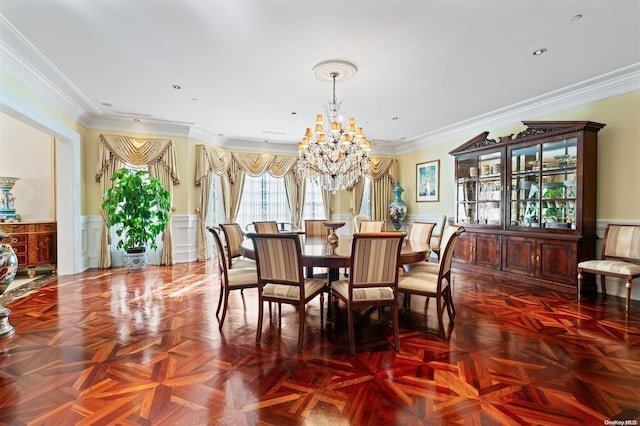 dining room featuring ornamental molding, parquet flooring, and a chandelier