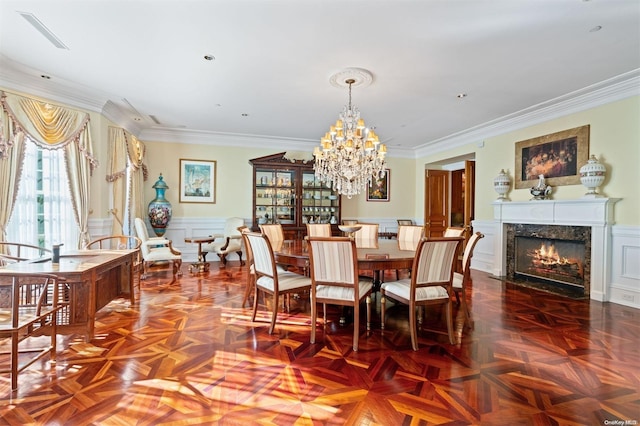 dining space featuring crown molding, a premium fireplace, and parquet flooring