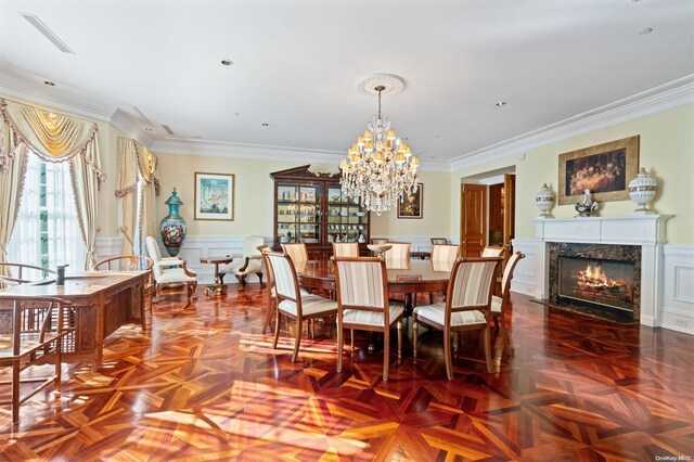 660 Chicken Valley Rd, Matinecock, NY 11560 - dining area featuring a wainscoted wall, a decorative wall, ornamental molding, a high end fireplace, and a chandelier