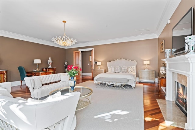 bedroom with dark hardwood / wood-style flooring, a premium fireplace, ornamental molding, and an inviting chandelier