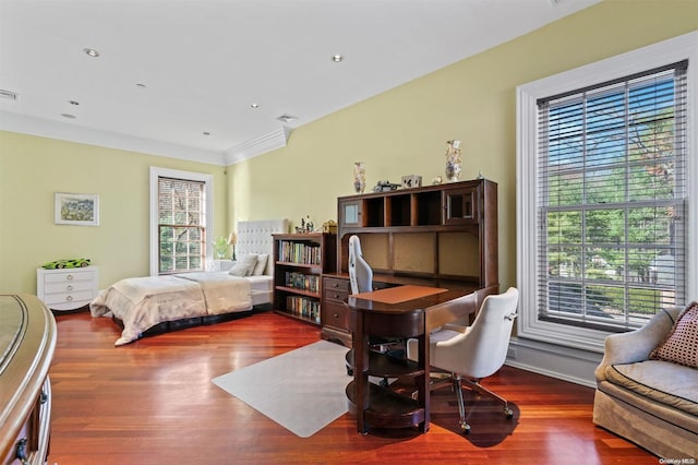 bedroom featuring hardwood / wood-style floors, ornamental molding, and multiple windows