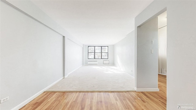 corridor with wood-type flooring