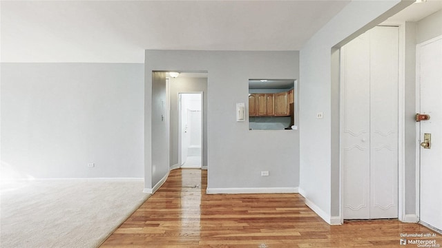 corridor with light hardwood / wood-style floors