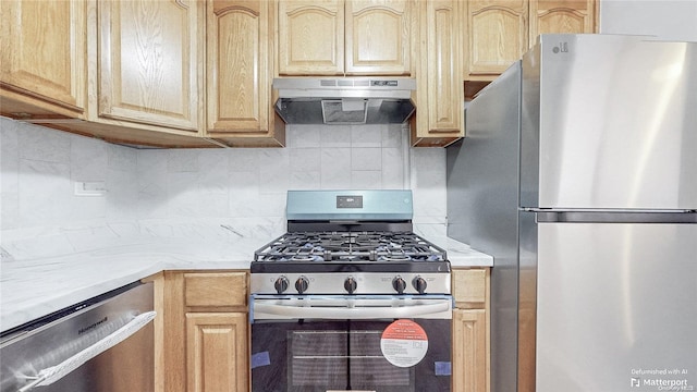 kitchen featuring decorative backsplash, appliances with stainless steel finishes, and light brown cabinets