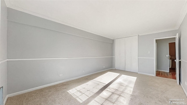 unfurnished bedroom with light carpet, a closet, and ornamental molding