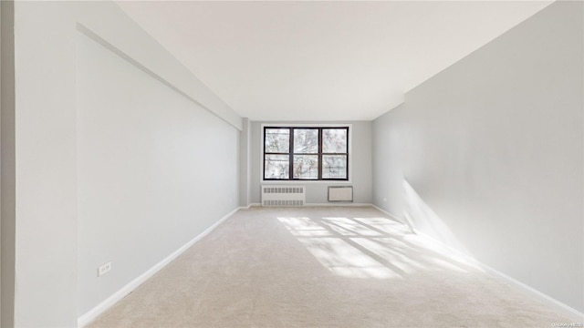 carpeted empty room with radiator heating unit