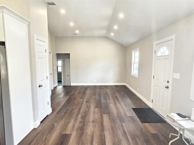 foyer with dark hardwood / wood-style floors and lofted ceiling