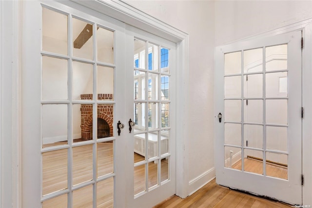 entryway featuring hardwood / wood-style floors and french doors