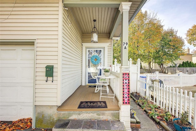 property entrance with covered porch and a garage