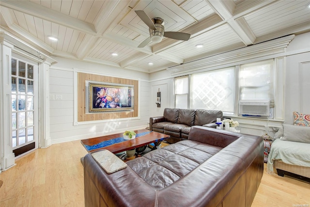 living room with beamed ceiling, a wealth of natural light, and light hardwood / wood-style flooring