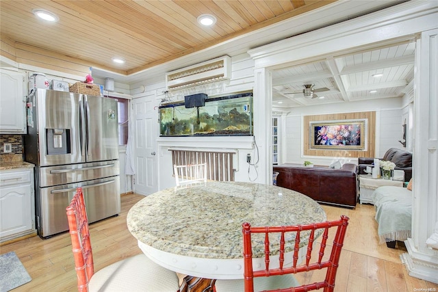 dining room with ceiling fan, light hardwood / wood-style floors, wooden ceiling, and wooden walls