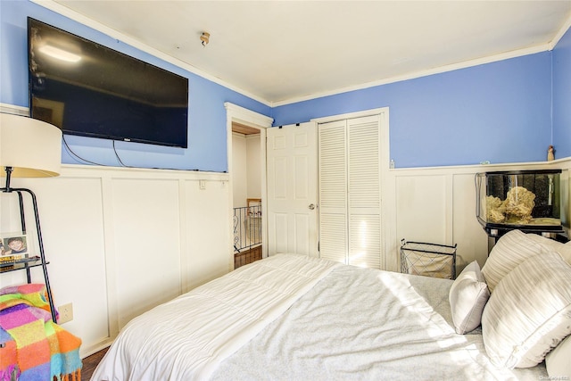 bedroom with crown molding and a closet