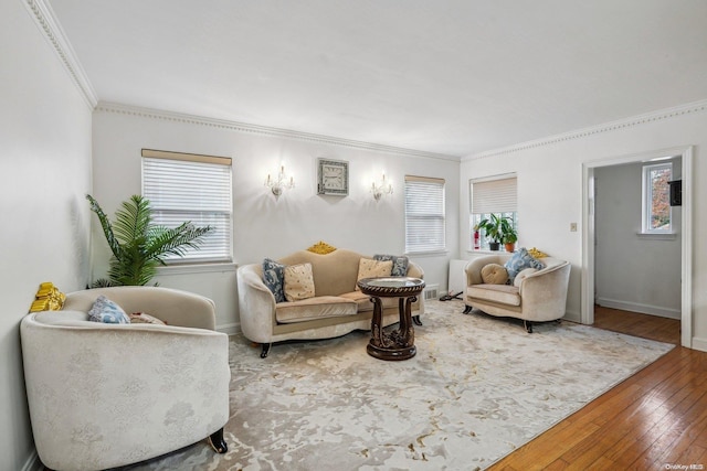 living room featuring hardwood / wood-style floors, plenty of natural light, and crown molding