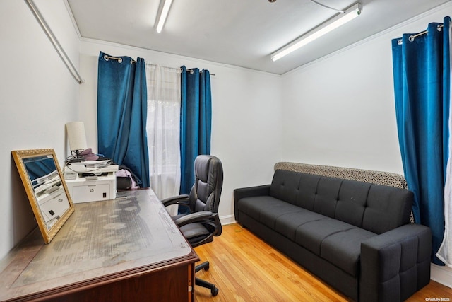 home office featuring hardwood / wood-style flooring and ornamental molding