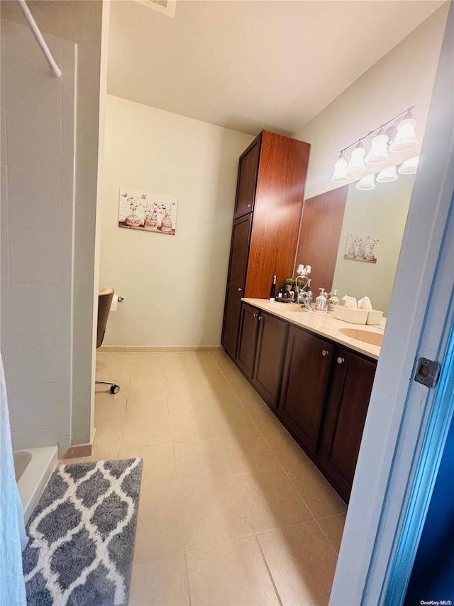 bathroom featuring tile patterned flooring and vanity