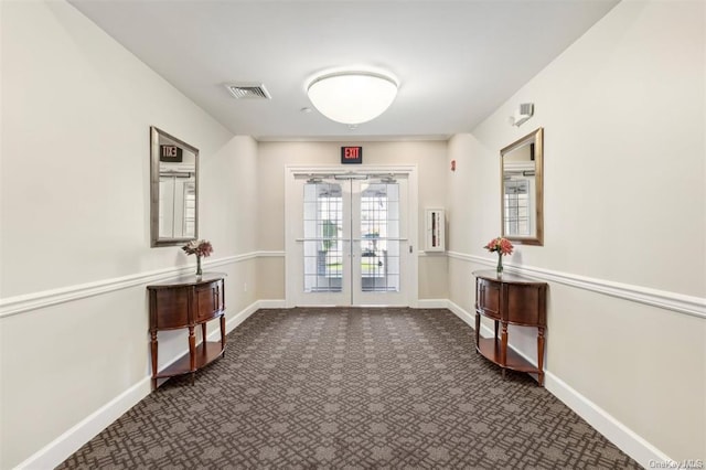 doorway to outside with dark carpet and french doors