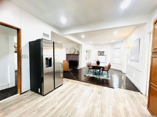 240 Pine St, Freeport, NY 11520 - interior space featuring light hardwood / wood-style floors, a brick fireplace, and a wall mounted AC
