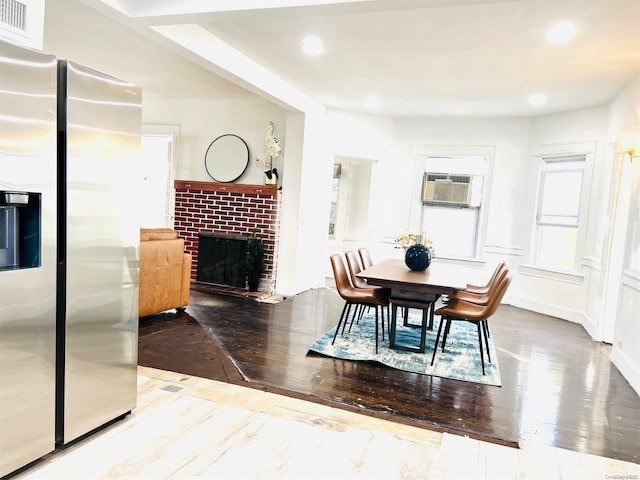240 Pine St, Freeport, NY 11520 - dining area with hardwood / wood-style flooring, cooling unit, and a brick fireplace