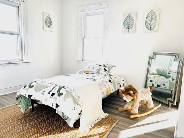 240 Pine St, Freeport, NY 11520 - bedroom with multiple windows and wood-type flooring