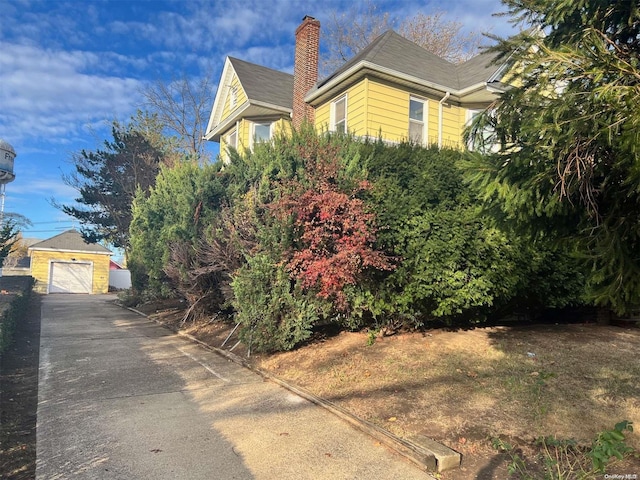 240 Pine St, Freeport, NY 11520 - view of side of property featuring a garage and an outbuilding