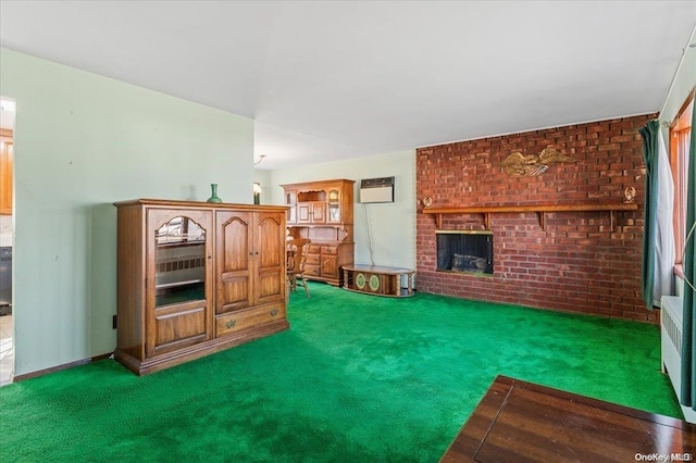 carpeted living room featuring a fireplace, a wall mounted AC, and brick wall