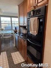 kitchen featuring dishwasher and black double oven