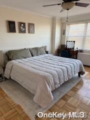 bedroom featuring ceiling fan and parquet floors