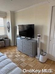 living room with ornamental molding and light parquet floors