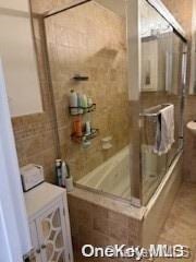 bathroom featuring a shower and washer / dryer