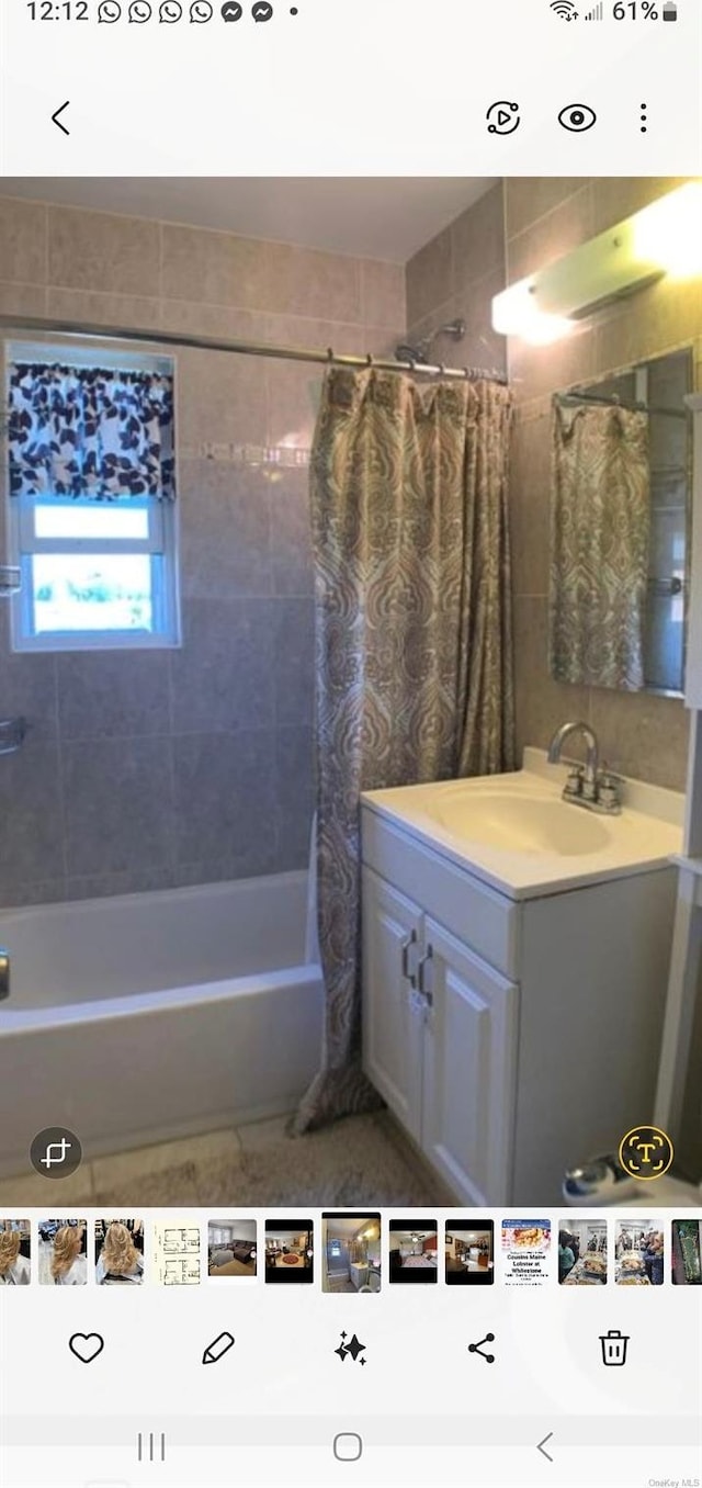 bathroom with vanity and shower / bathtub combination with curtain