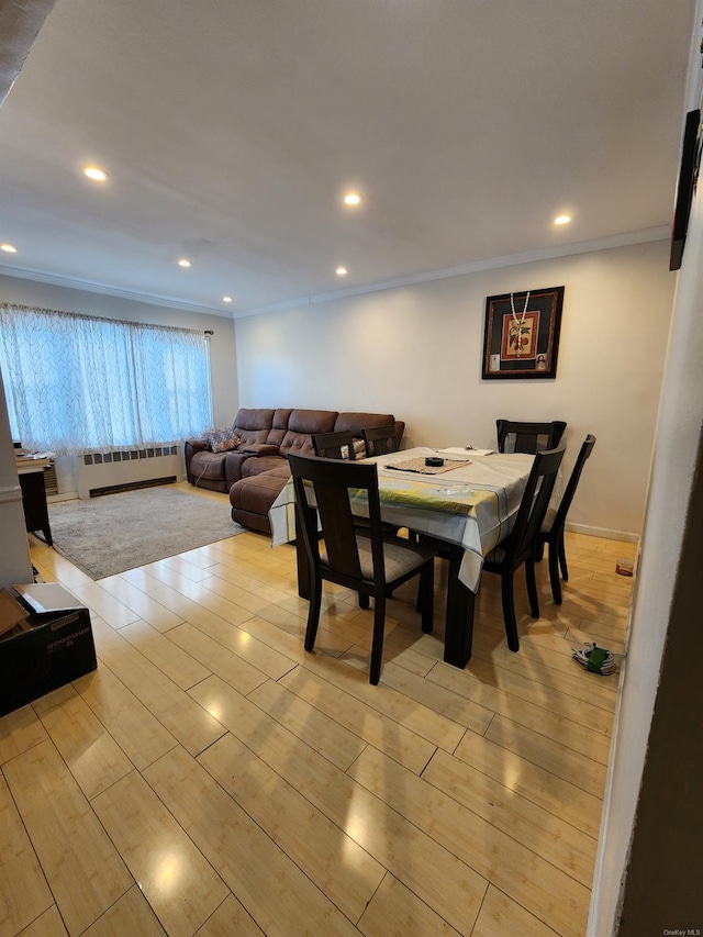 dining area with crown molding and baseboard heating